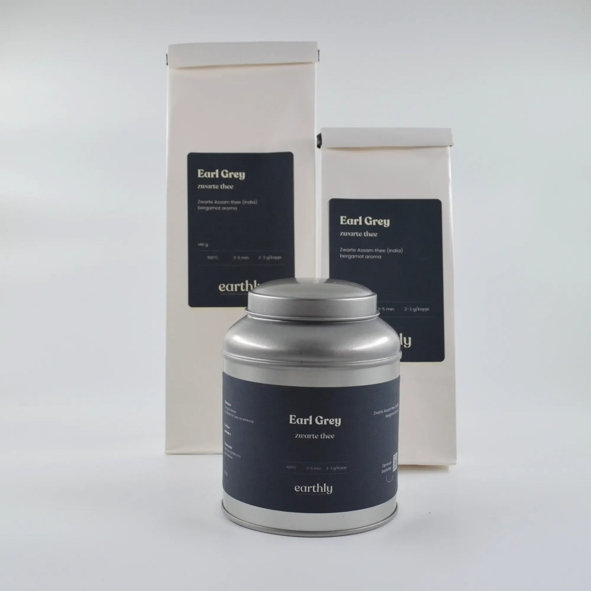 Earthly Earl Grey zwarte thee in metalen blik en twee witte verpakkingen met zwarte labels