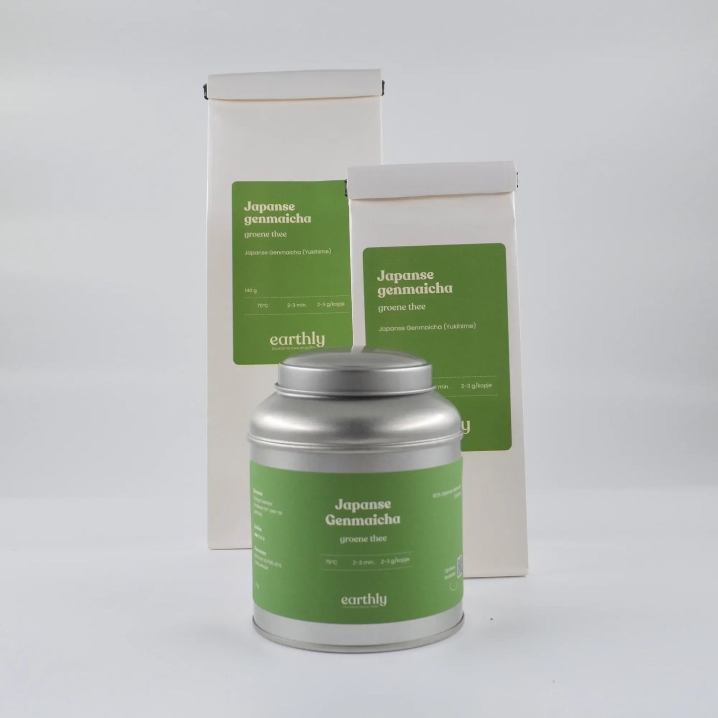 Verpakking van Japanse Genmaicha groene thee met zilveren theeblik en witte zakken met groene etiketten