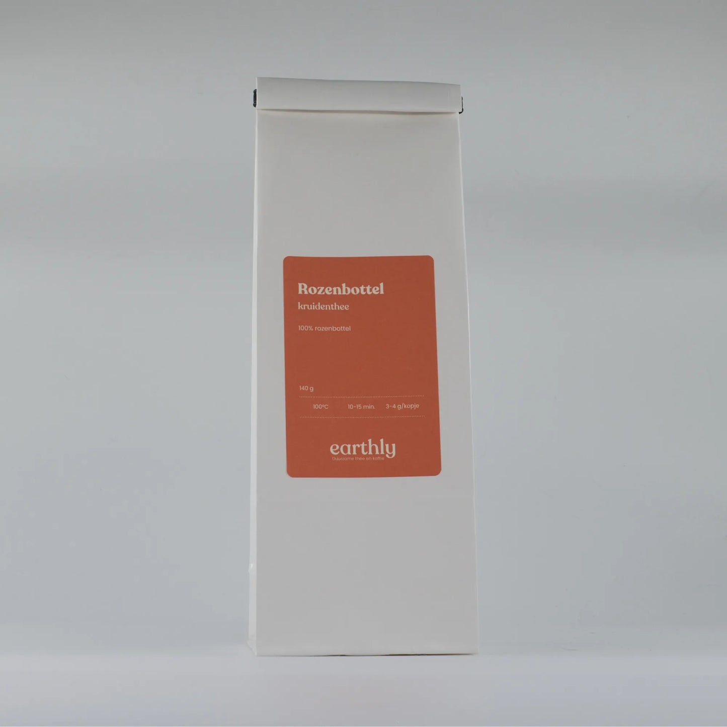 Witte verpakking met oranje label van Earthly Rozenbottel kruidenthee, 140 g